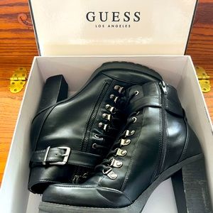 Black heeled combat style black boots by Guess.